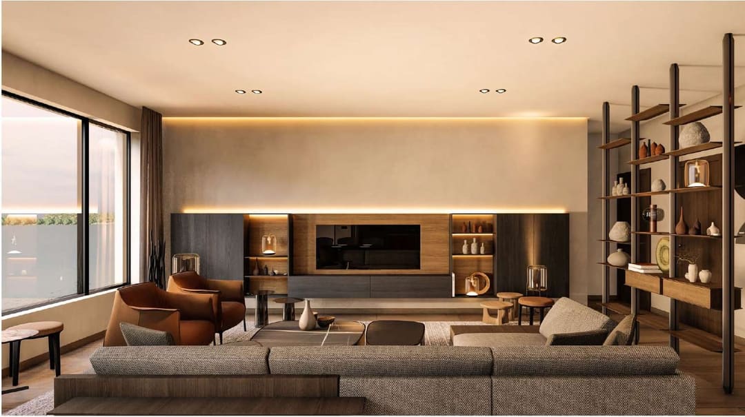 Living room with a long grey sofa, leather armchairs and open shelving